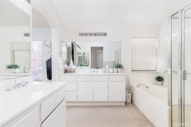a bedroom with a bed and a potted plant