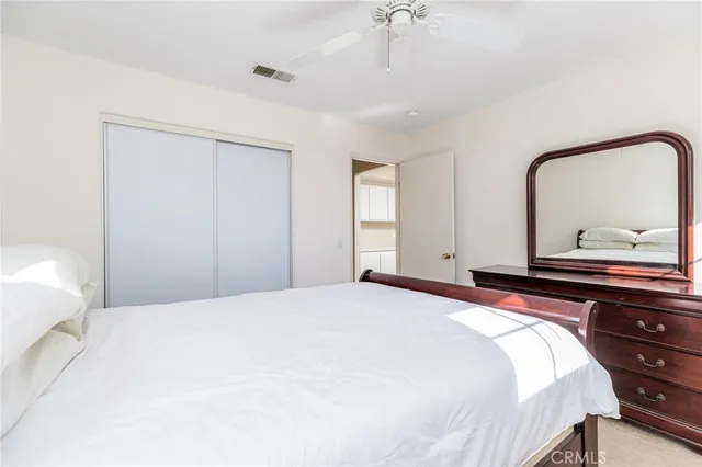 a bedroom with a bed and a dresser in it