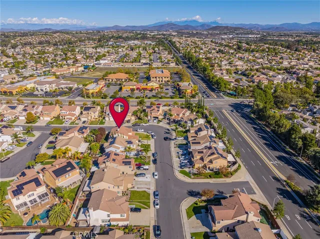 aerial view of a house with outdoor space and lake view in back