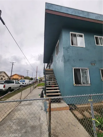 a view of a patio with wooden floor and fence