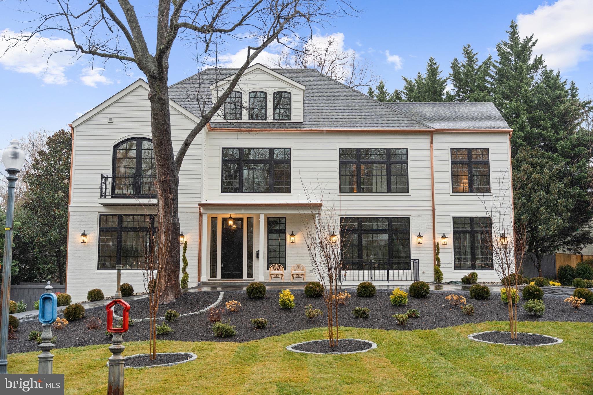 a front view of a house with swimming pool and chairs