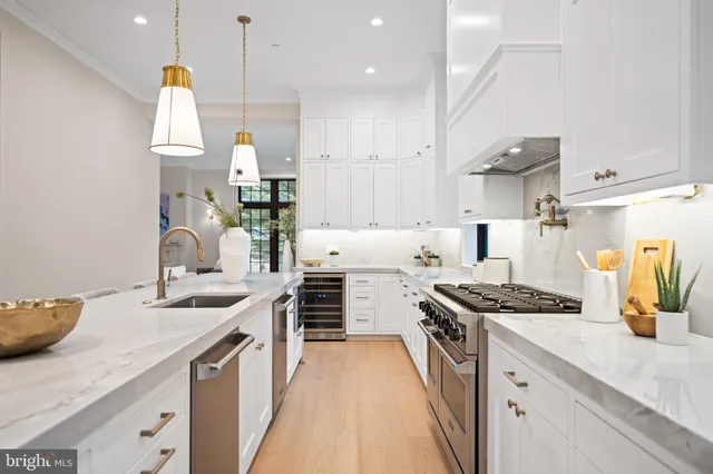 a kitchen with stainless steel appliances a sink stove and refrigerator