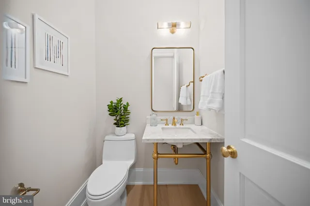 a bathroom with a toilet a sink and mirror