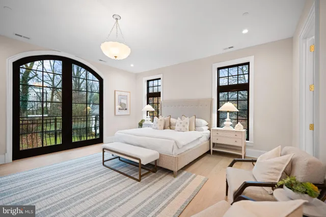 a spacious bedroom with a bed and a large window