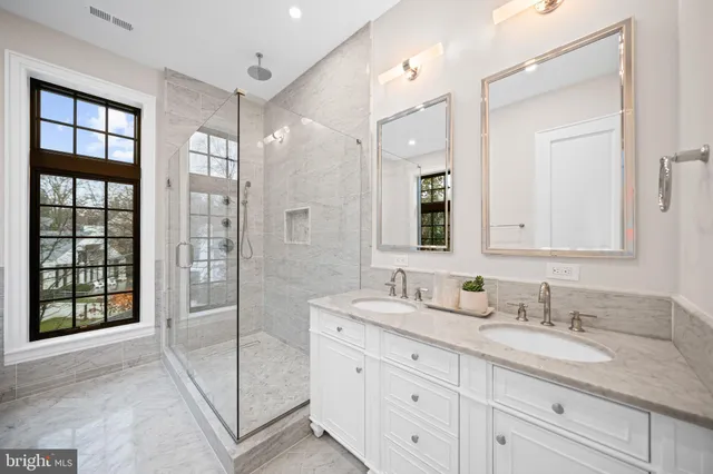 a bathroom with a granite countertop sink mirror and double