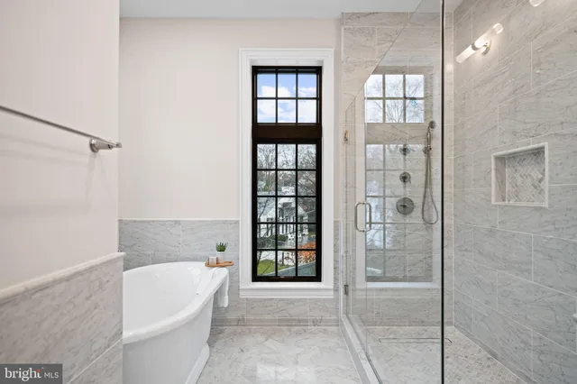a spacious bathroom with a bathtub and shower