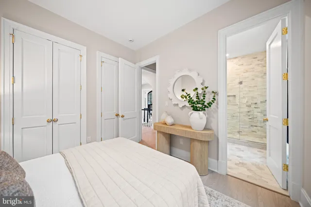 a bedroom with a bed and a chandelier