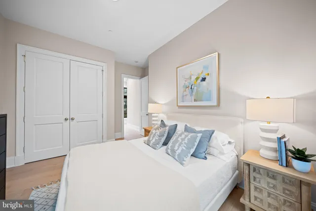 a bedroom with a bed and a painting on the wall