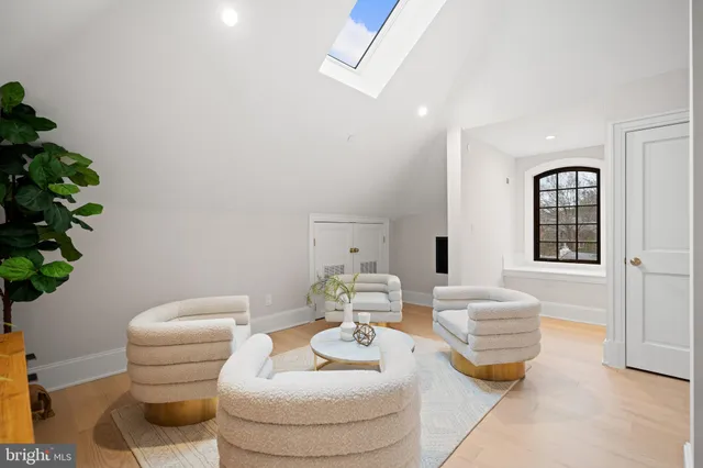 a living room with furniture and flowers