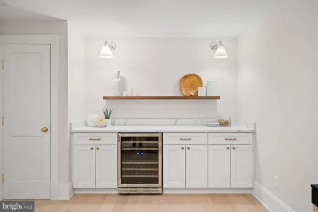 a view of cabinets a sink and a stove in a kitchen