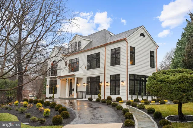a front view of a house with a yard and outdoor seating