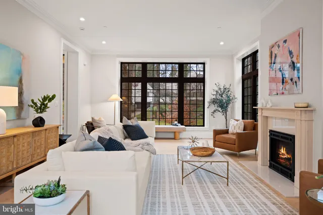 a living room with furniture fireplace and window