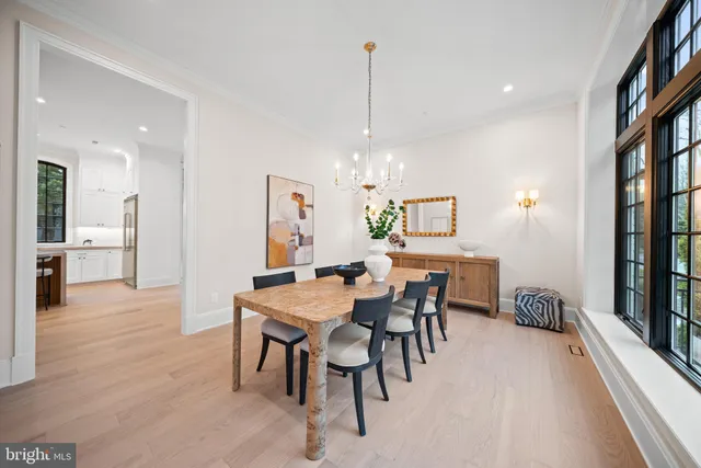 a view of a dining room with furniture and a chandelier