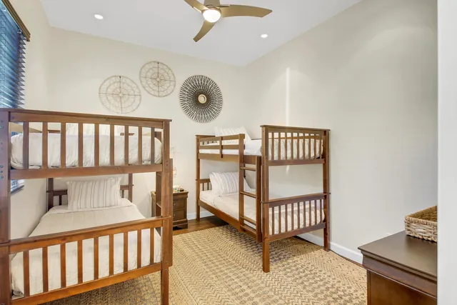 a bedroom with a bed a couch and large window