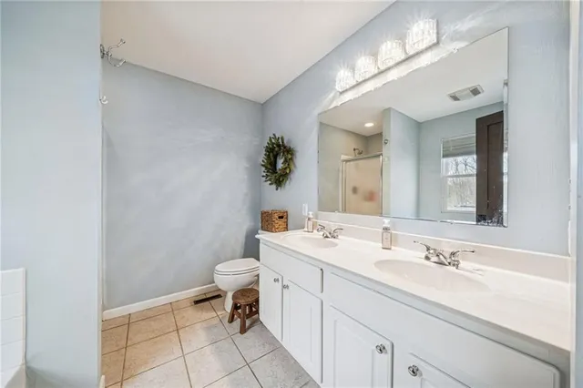 a bathroom with a tub sink and mirror