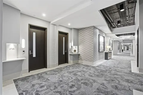 an empty room and chandelier fan