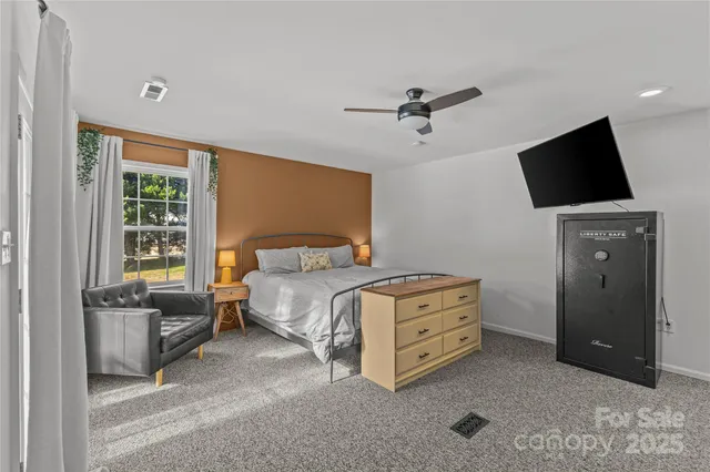 a bedroom with a bed and a television