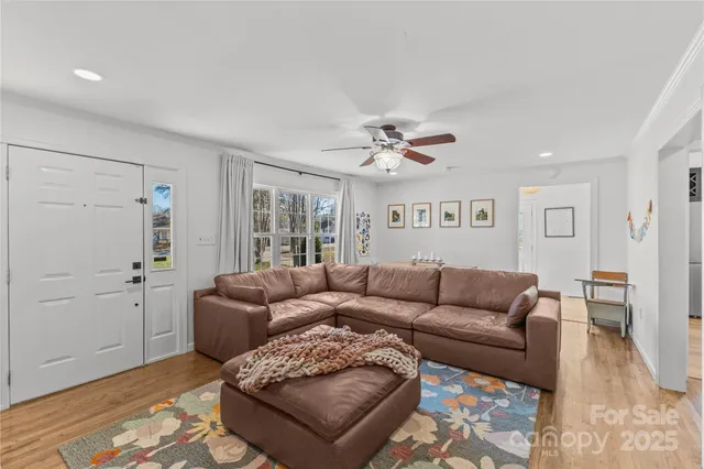 a living room with furniture and a wooden floor