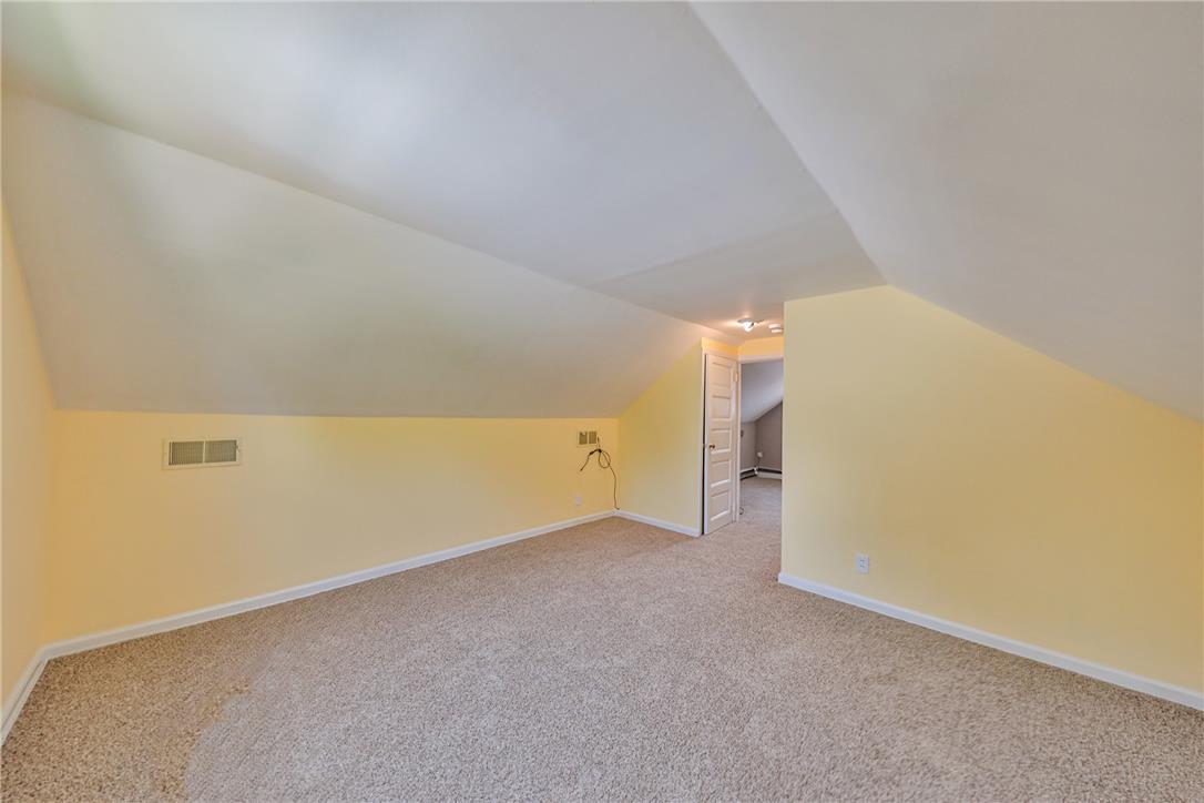 3050 Cornwall Road Bethlehem, PA 18017 - Photo 45 of 80 A versatile attic space awaits transformation, featuring sloped ceilings and plush carpeting.