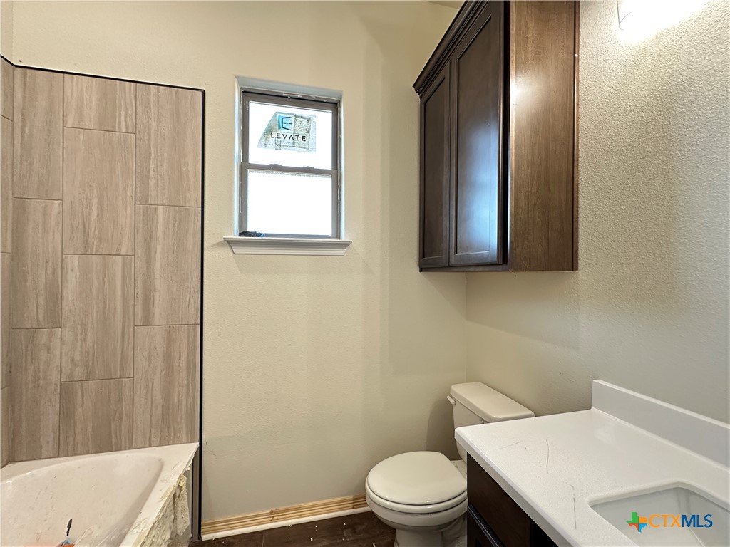 4417 Agave Trail Temple, TX 76502 - Photo 10 of 19 a white toilet sitting next to a bathroom sink and tub