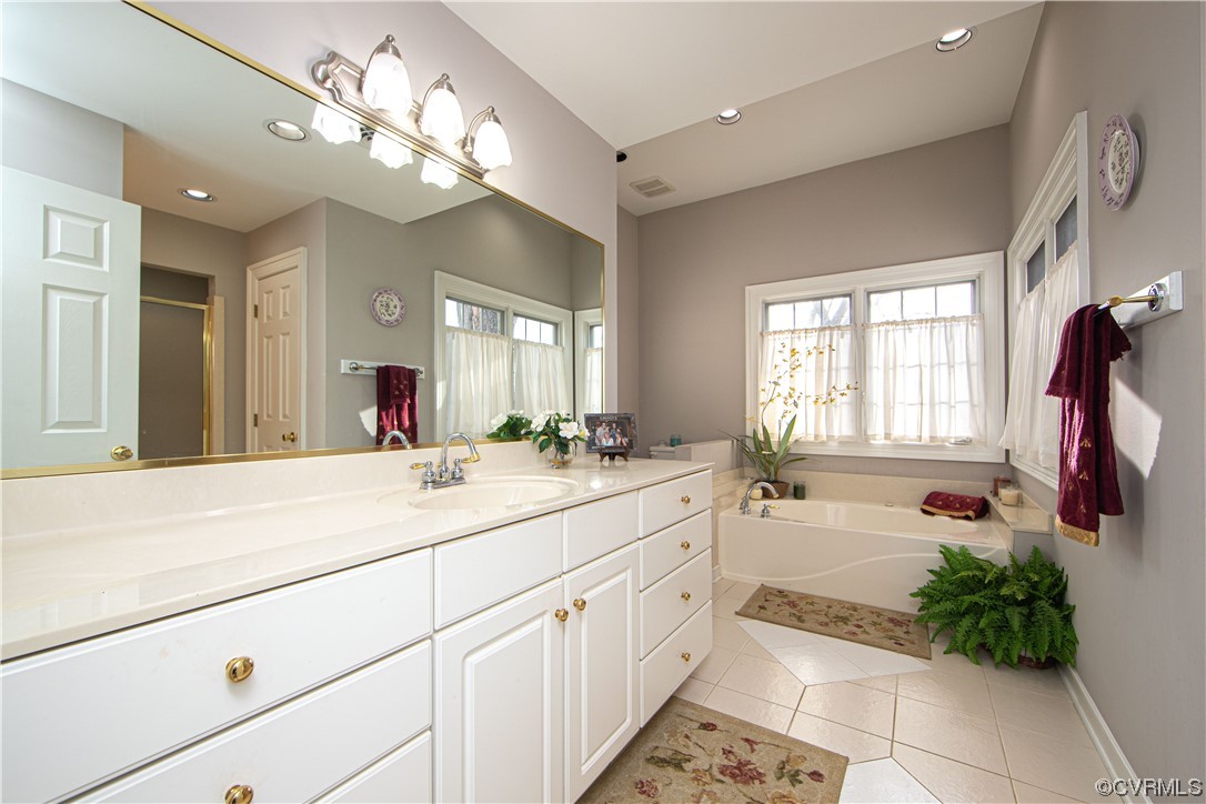 2729 Judes Ferry Road Powhatan, VA 23139 - Photo 26 of 50 Primary bathroom has two vanities, jetted tub and a shower. Tile floor and linen closet