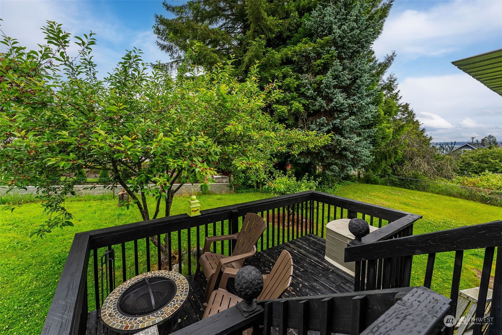7911 East Maple Street Port Orchard, WA 98366 - Photo 12 of 39 a view of a balcony with wooden floor and outdoor seating