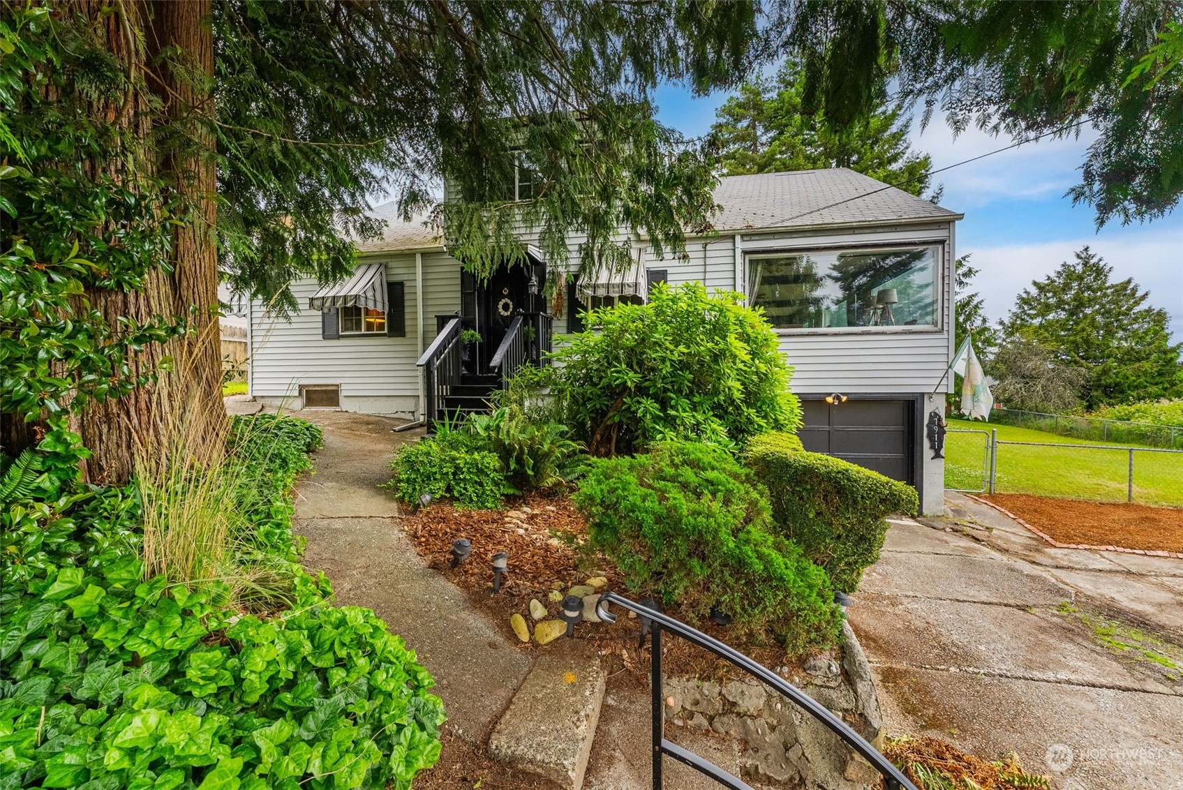 7911 East Maple Street Port Orchard, WA 98366 - Photo 35 of 39 a house with trees in front of it