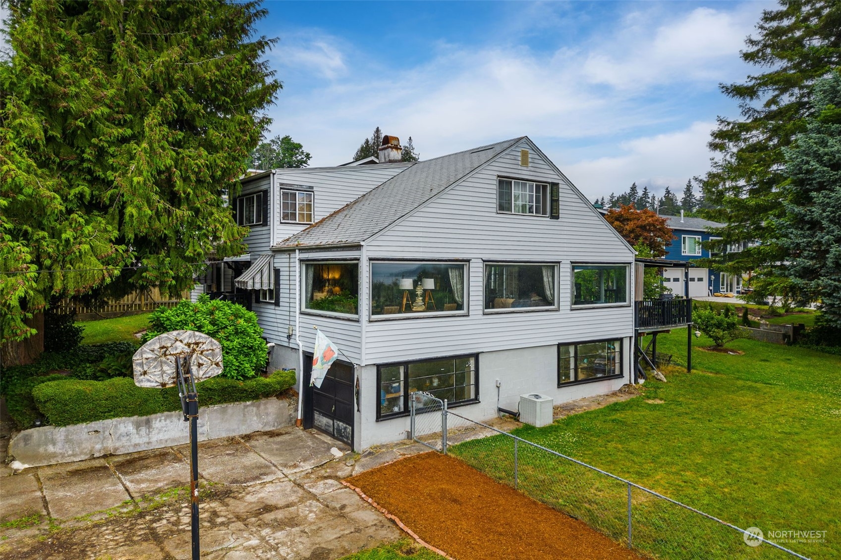 7911 East Maple Street Port Orchard, WA 98366 - Photo 5 of 39 a front view of a house with a garden