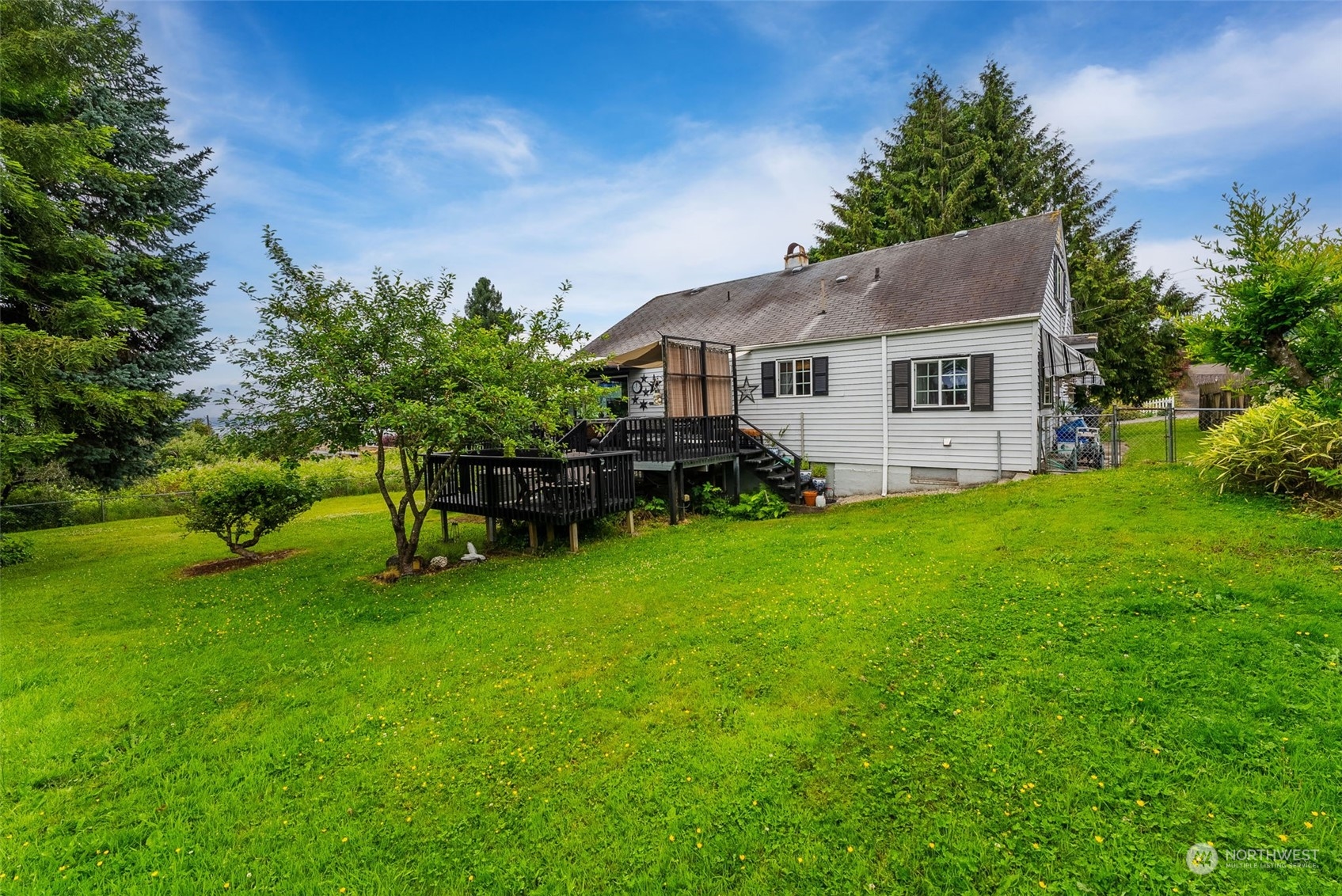 7911 East Maple Street Port Orchard, WA 98366 - Photo 7 of 39 a backyard of a house with table and chairs