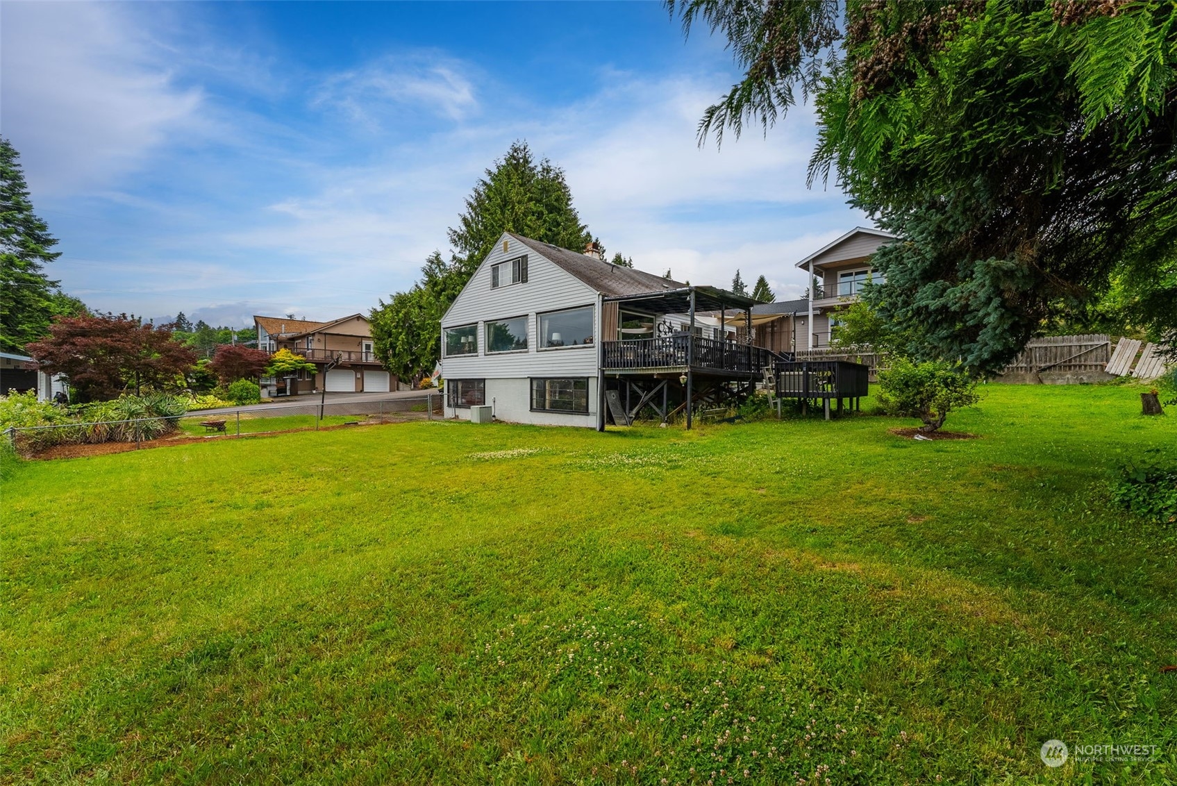 7911 East Maple Street Port Orchard, WA 98366 - Photo 8 of 39 a view of a house with a big yard and large trees