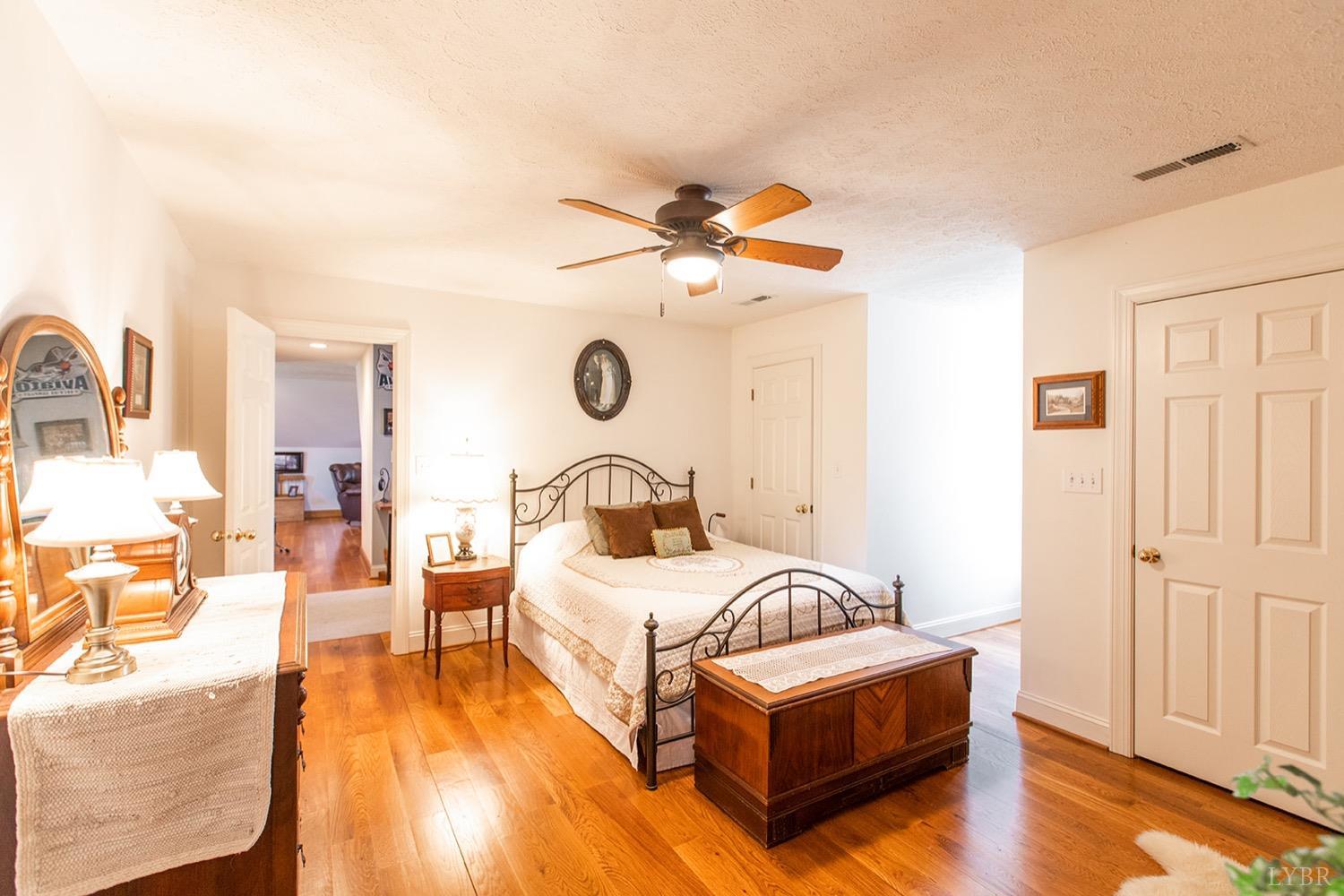 2096 Austin Mill Road Evington, VA 24550 - Photo 24 of 44 a bedroom with a bed and a chandelier