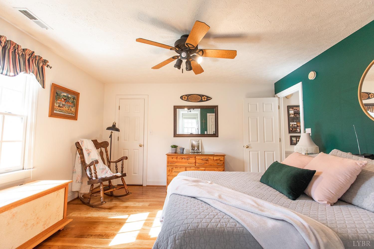 2096 Austin Mill Road Evington, VA 24550 - Photo 28 of 44 a bedroom with a bed and a chandelier