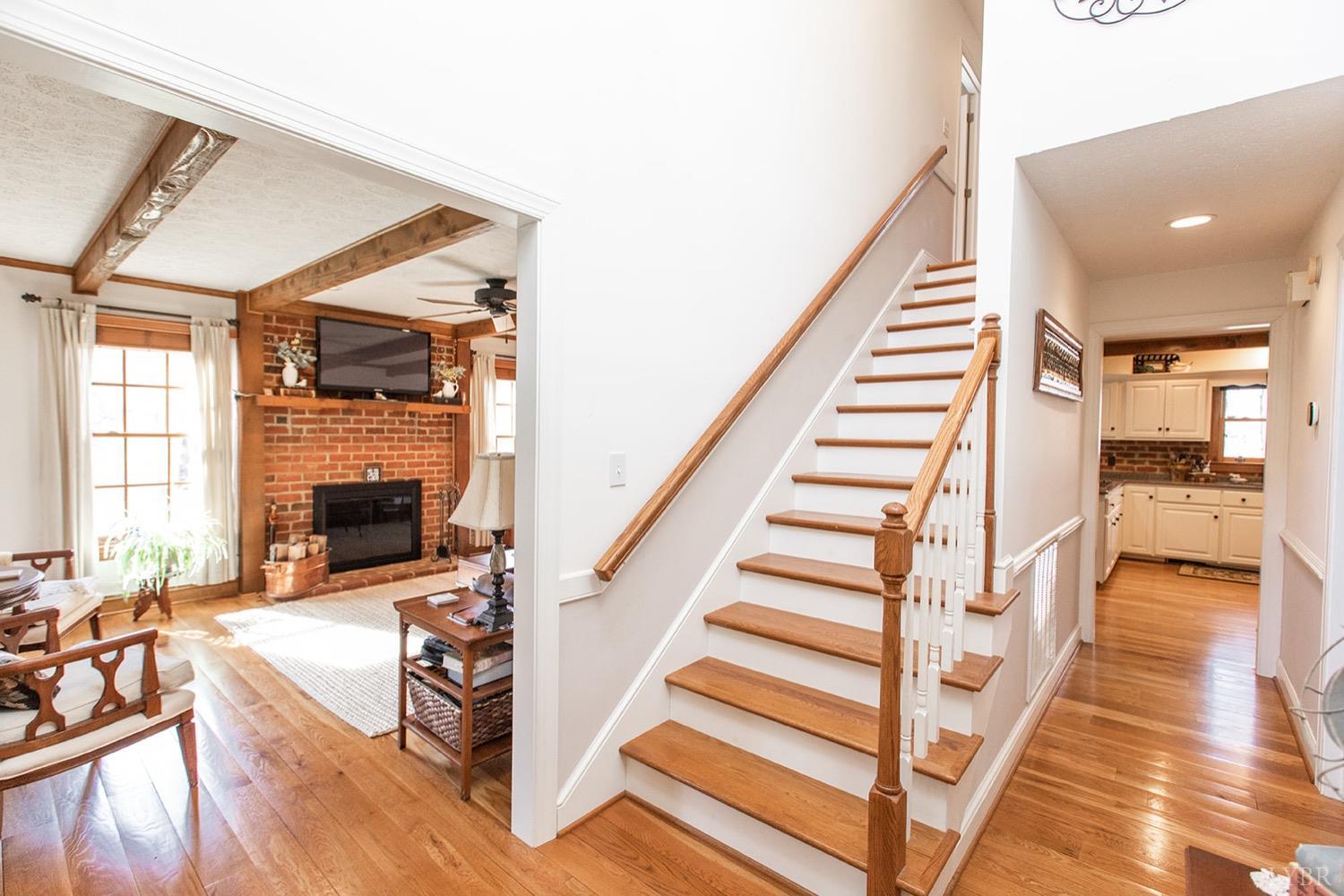 2096 Austin Mill Road Evington, VA 24550 - Photo 6 of 44 a view of a livingroom with wooden floor and a fireplace