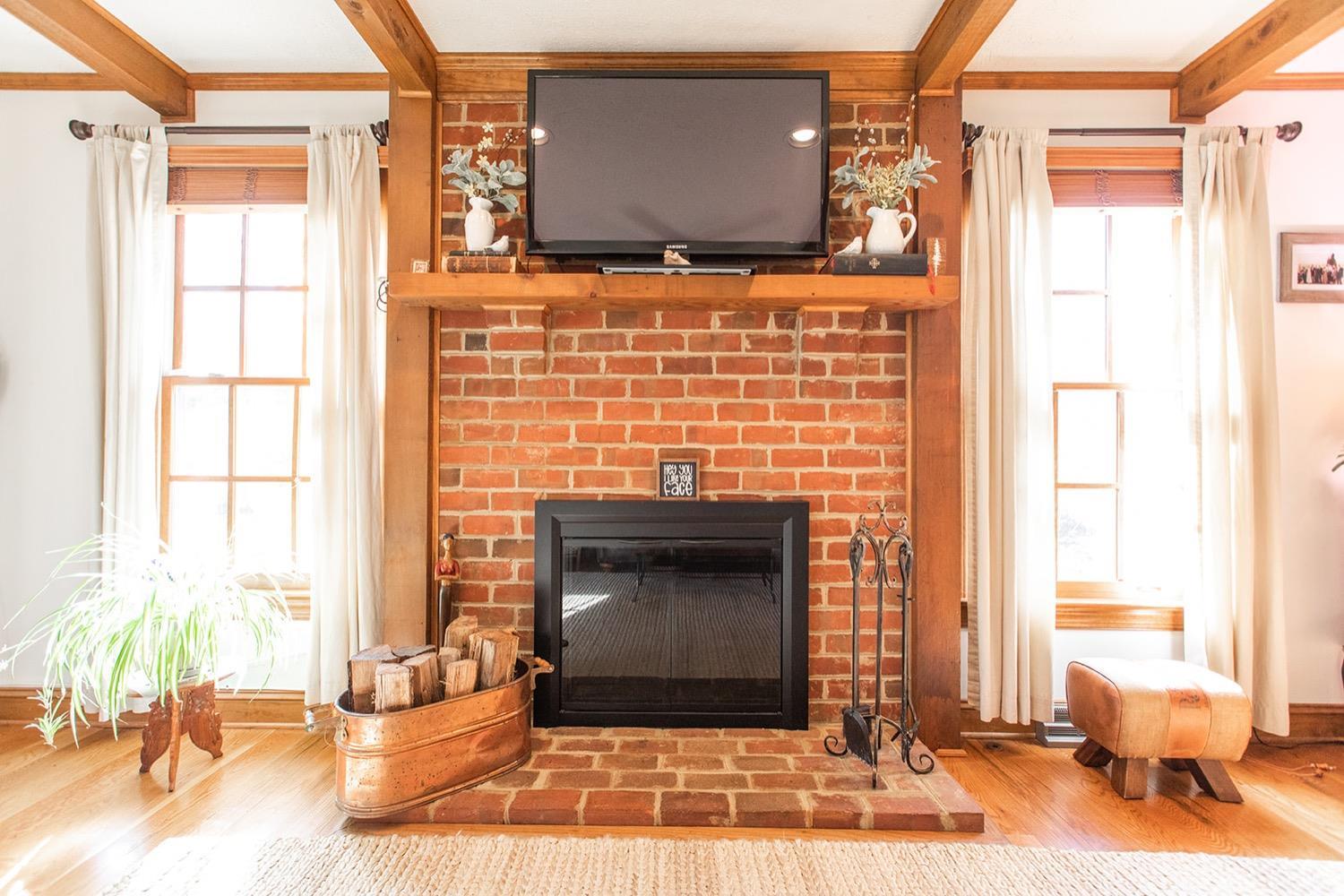 2096 Austin Mill Road Evington, VA 24550 - Photo 8 of 44 a living room with a fireplace windows and a table