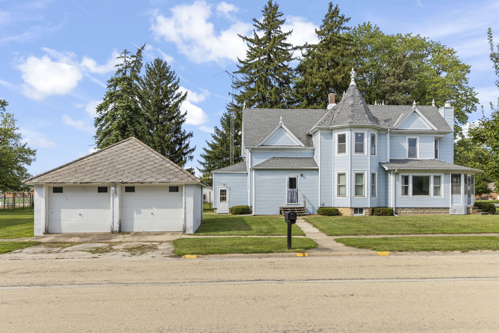 301 North Main Street Herscher, IL 60941 - Photo 30 of 34 a front view of a house with a garden and trees
