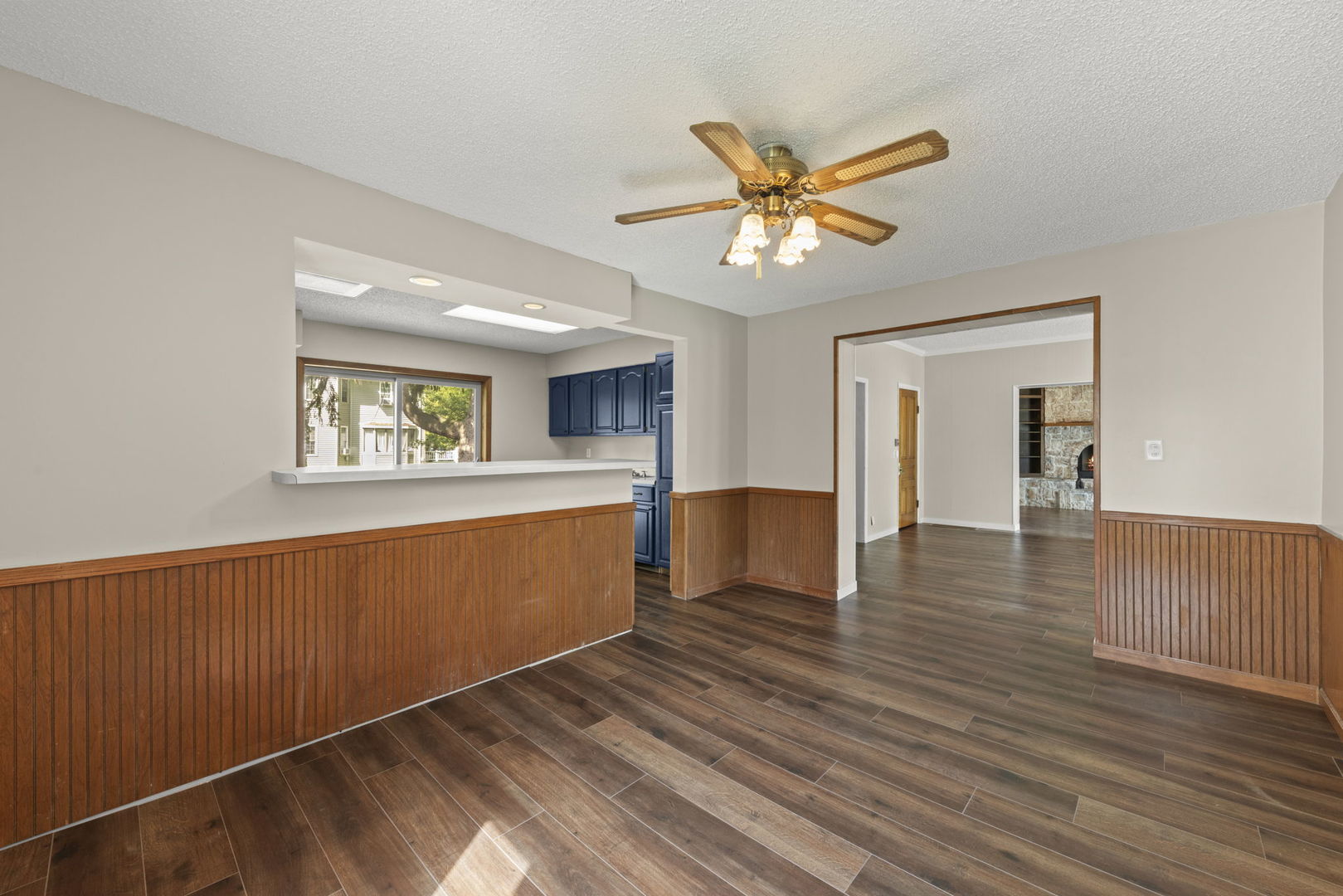 301 North Main Street Herscher, IL 60941 - Photo 8 of 34 a view of a kitchen with wooden floor and a ceiling fan