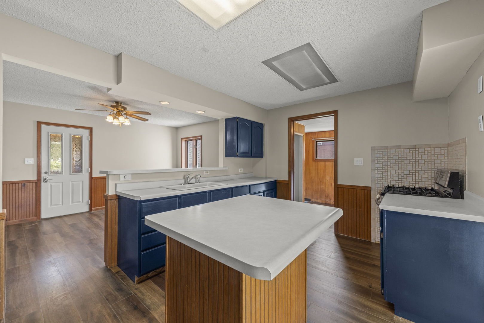 301 North Main Street Herscher, IL 60941 - Photo 10 of 34 a kitchen with granite countertop a stove kitchen island a refrigerator wooden floor and a dining table