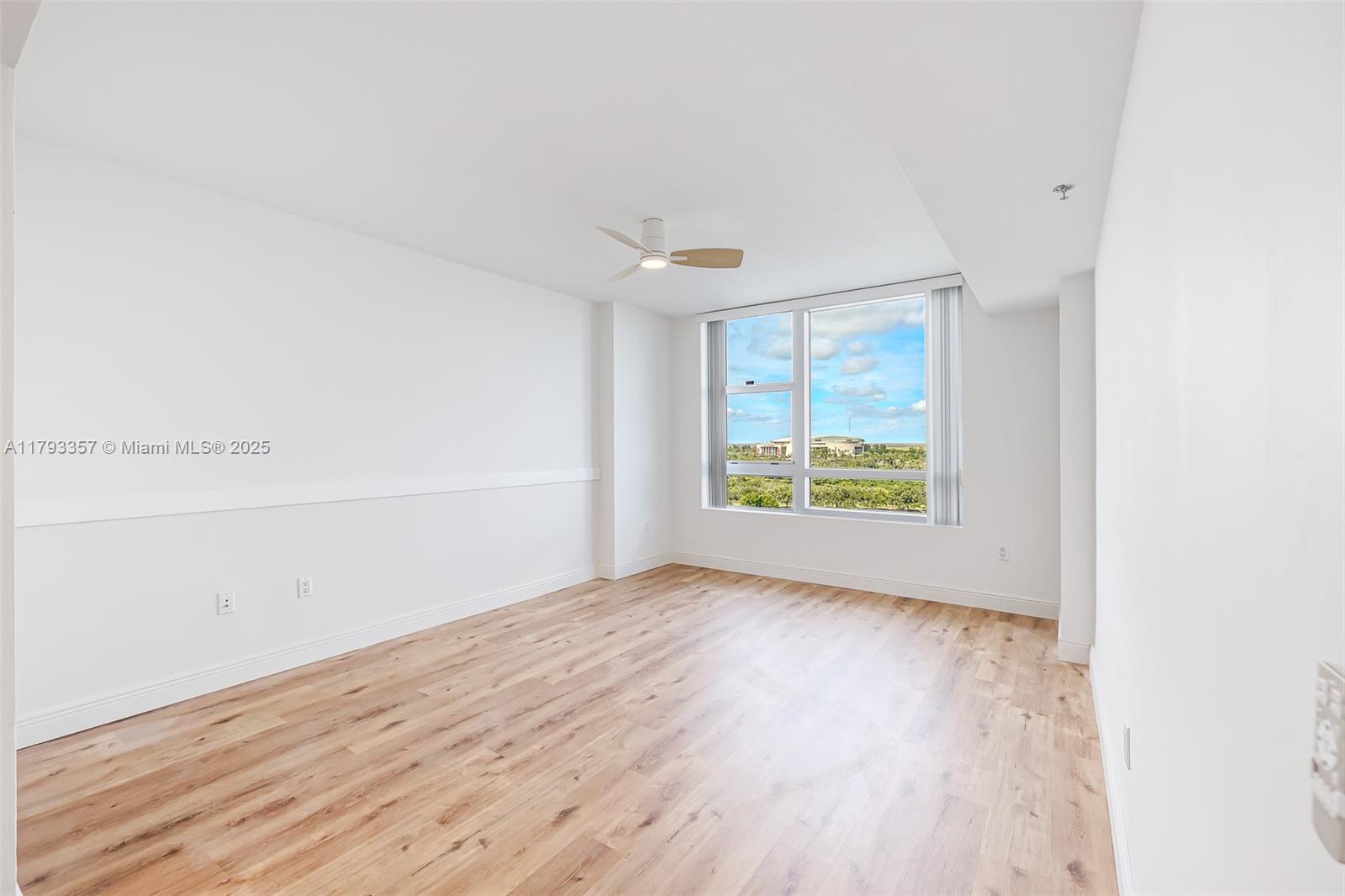 2641 North Flamingo Road, Unit 1205N Sunrise, FL 33323 - Photo 12 of 31 an empty room with wooden floor and windows