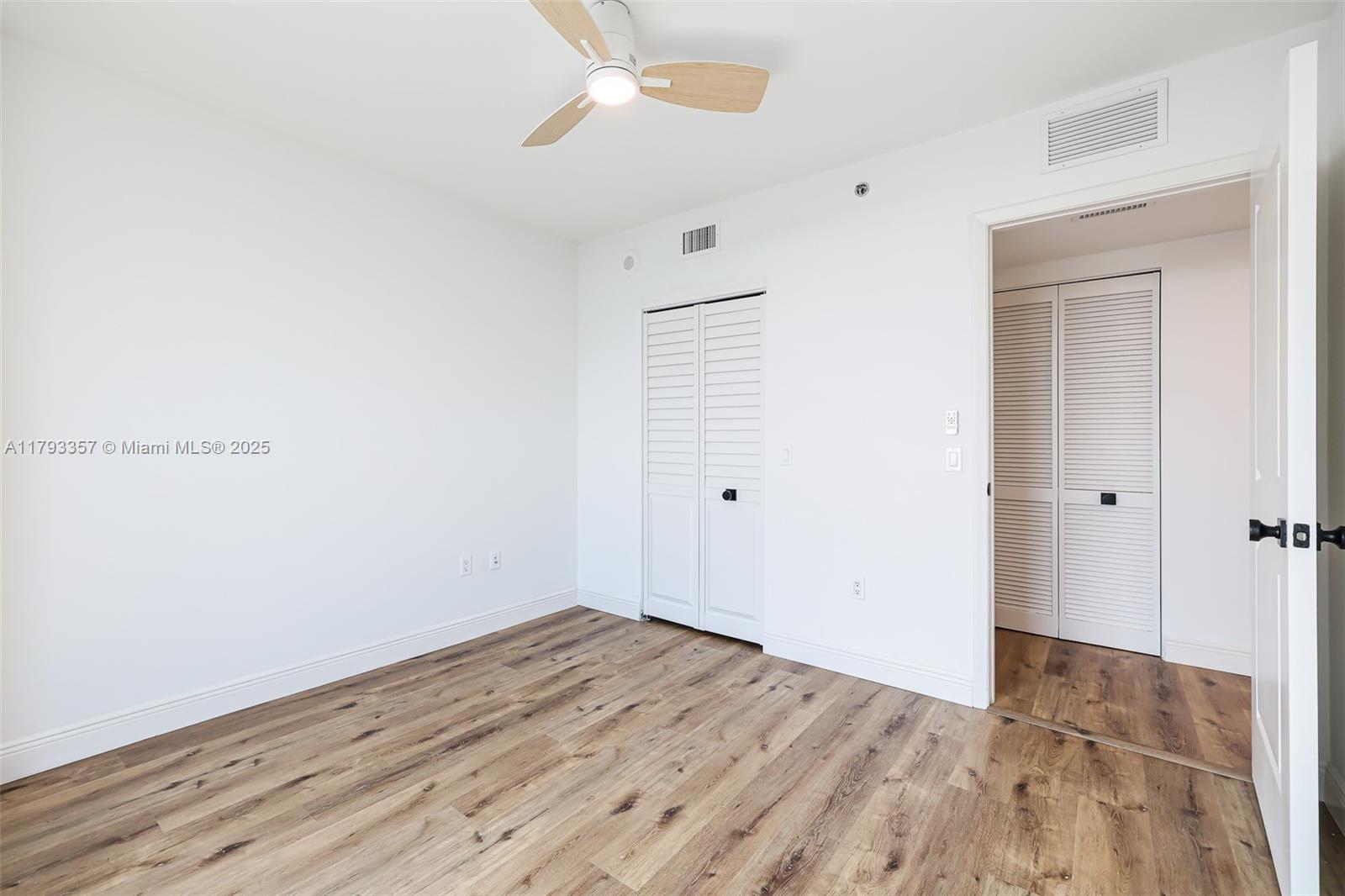 2641 North Flamingo Road, Unit 1205N Sunrise, FL 33323 - Photo 20 of 31 an empty room with wooden floor and windows
