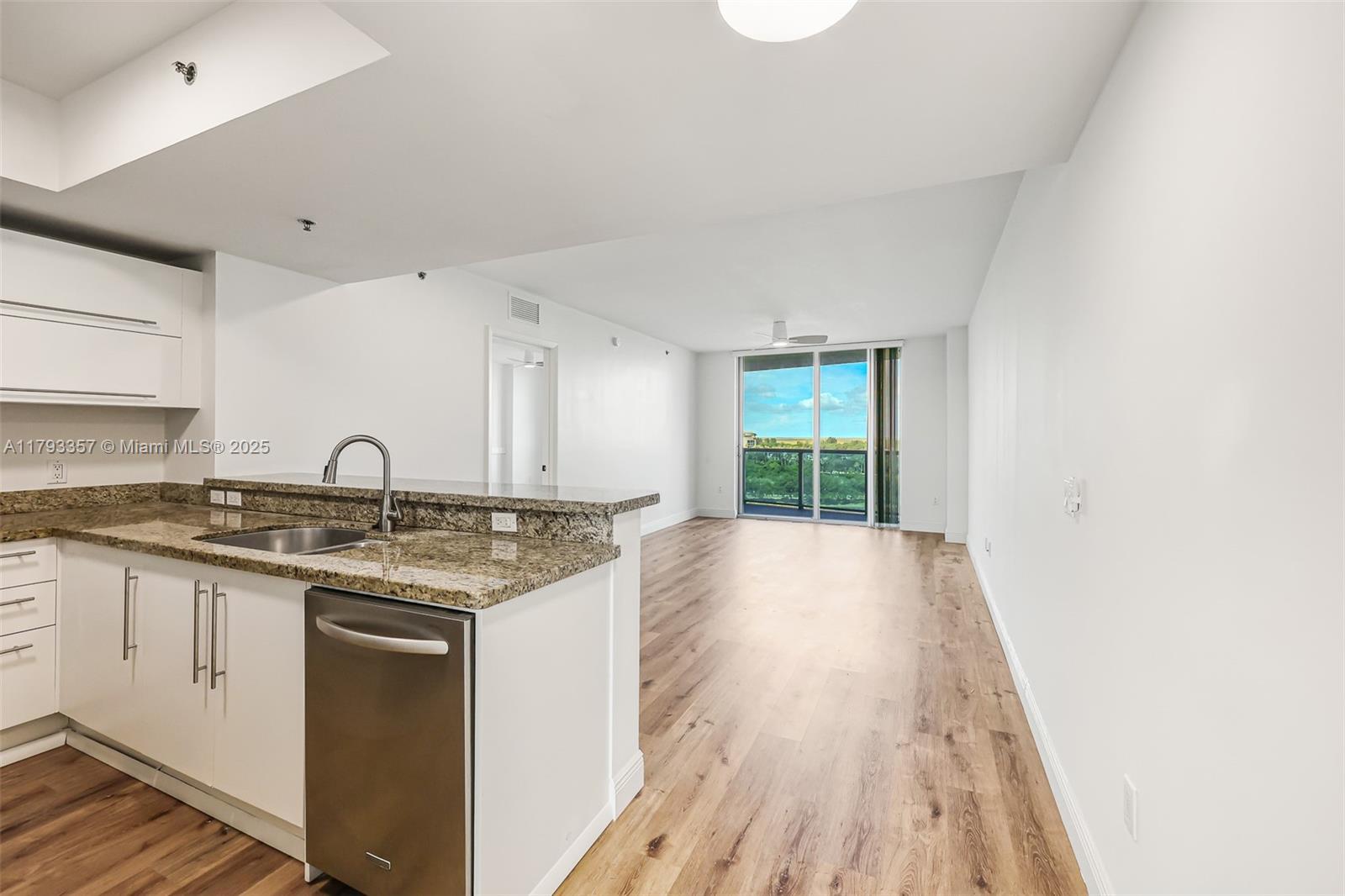 2641 North Flamingo Road, Unit 1205N Sunrise, FL 33323 - Photo 9 of 31 a view of a kitchen with sink cabinets and wooden floor