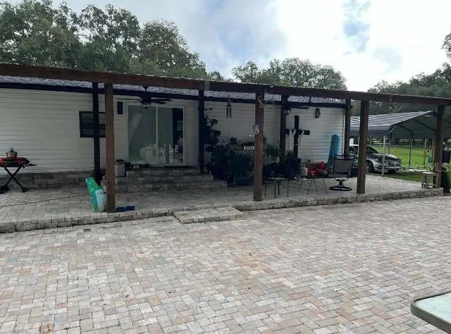 a view of a house with backyard space and porch