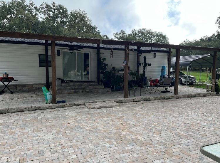 a view of a house with backyard space and porch