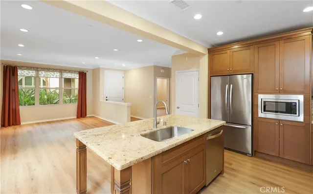a kitchen with kitchen island a sink stove and refrigerator