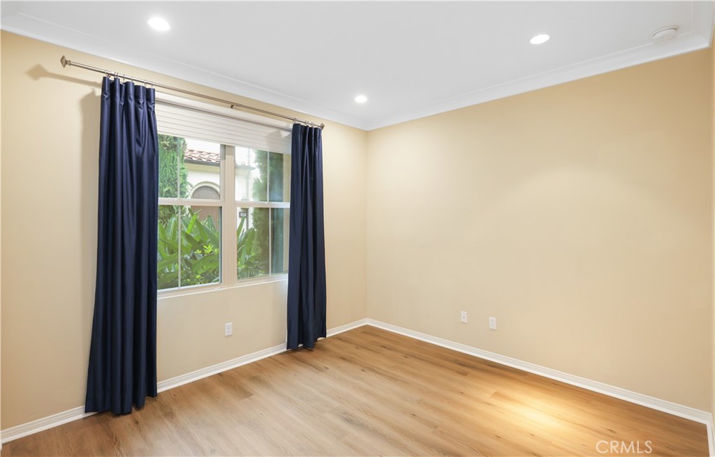 220 Kempton Irvine, CA 92620 - Photo 14 of 42 a view of an empty room with wooden floor and a window