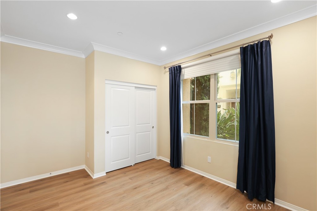 220 Kempton Irvine, CA 92620 - Photo 15 of 42 an empty room with wooden floor and windows