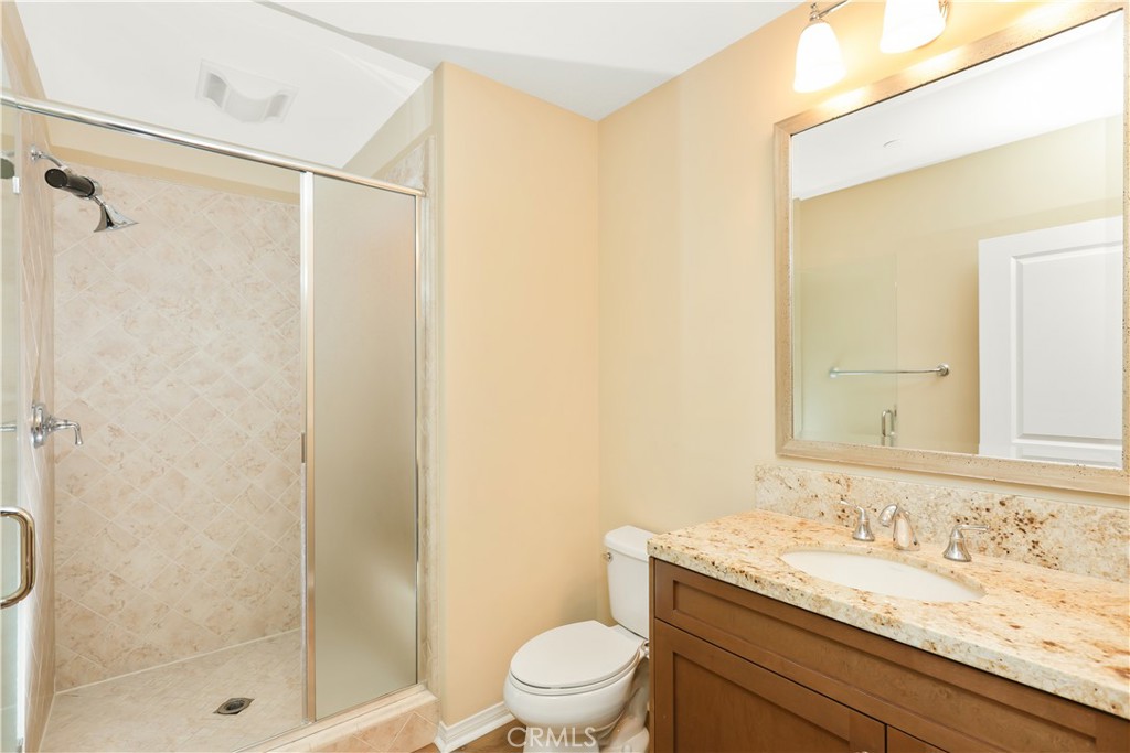 220 Kempton Irvine, CA 92620 - Photo 16 of 42 a bathroom with a granite countertop sink a toilet and shower