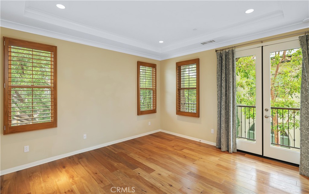 220 Kempton Irvine, CA 92620 - Photo 18 of 42 a view of an empty room with wooden floor and a window
