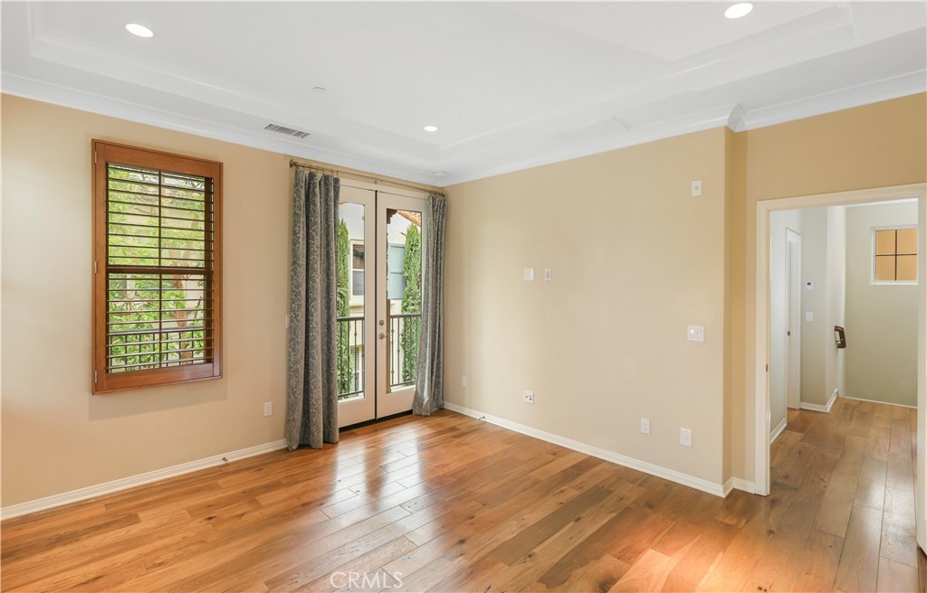 220 Kempton Irvine, CA 92620 - Photo 19 of 42 an empty room with wooden floor and windows