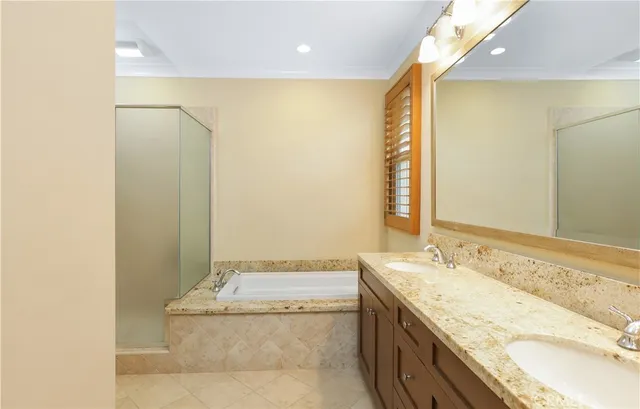 a bathroom with a granite countertop sink a mirror and a bathtub