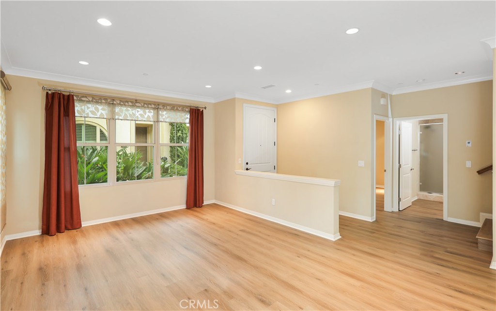 220 Kempton Irvine, CA 92620 - Photo 6 of 42 a view of an empty room with wooden floor and a window